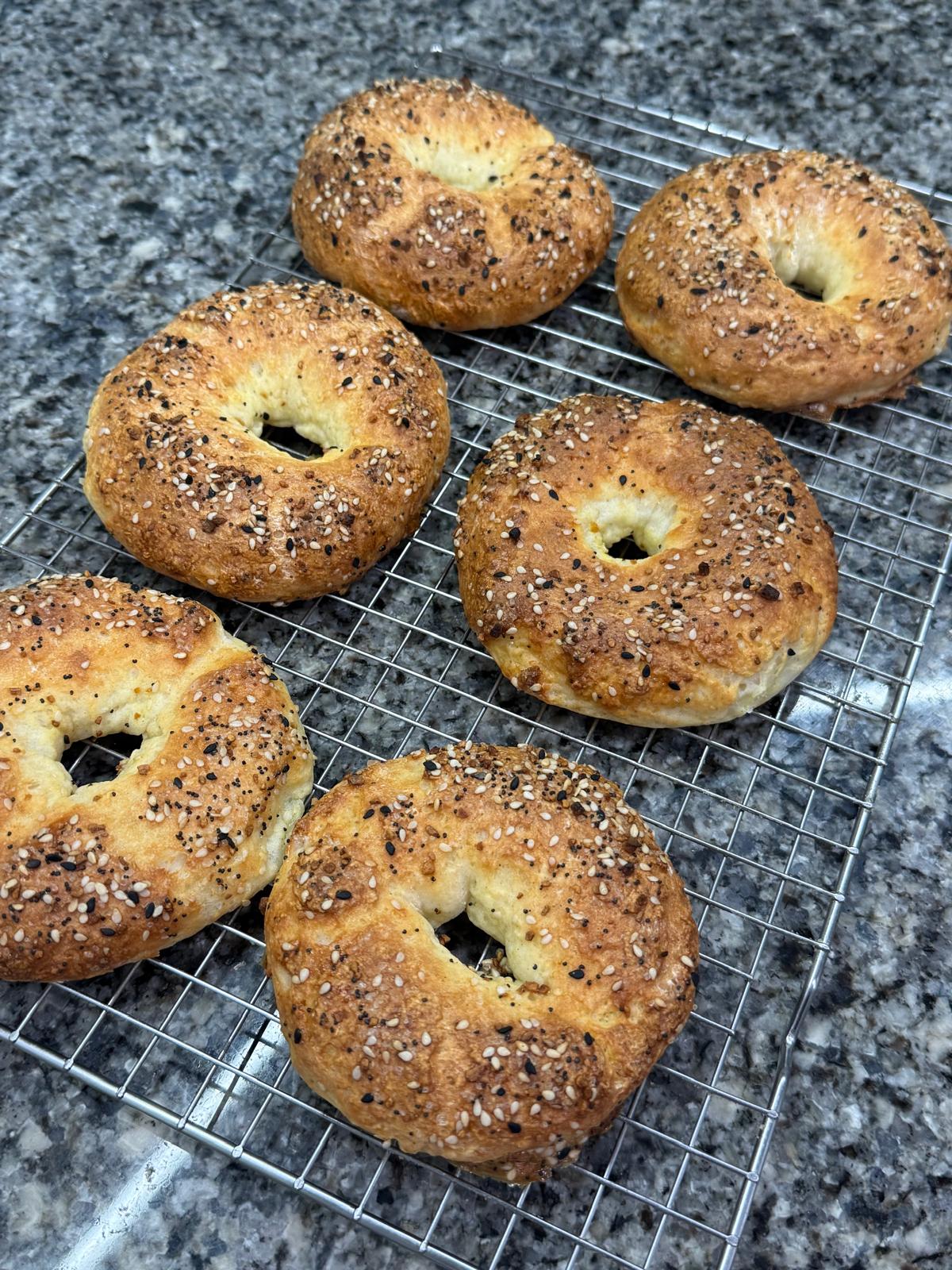 Everything bagels on a rack