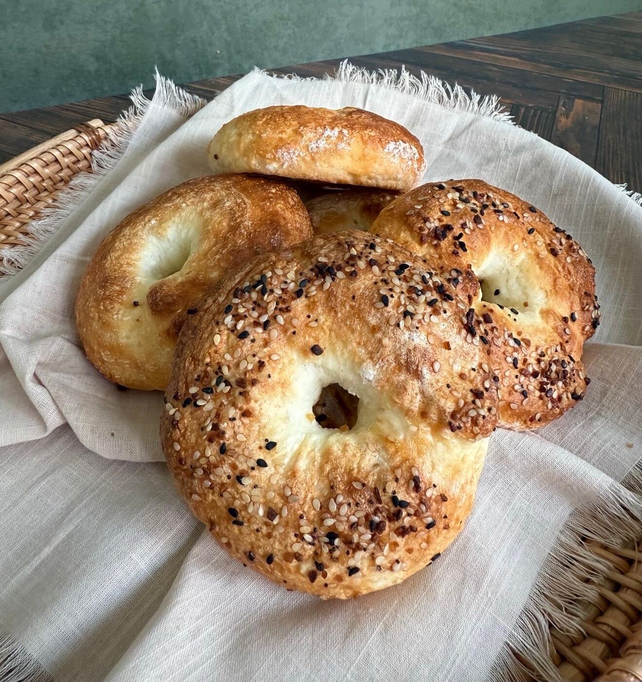 Golden gluten-free bagels stacked in a basket