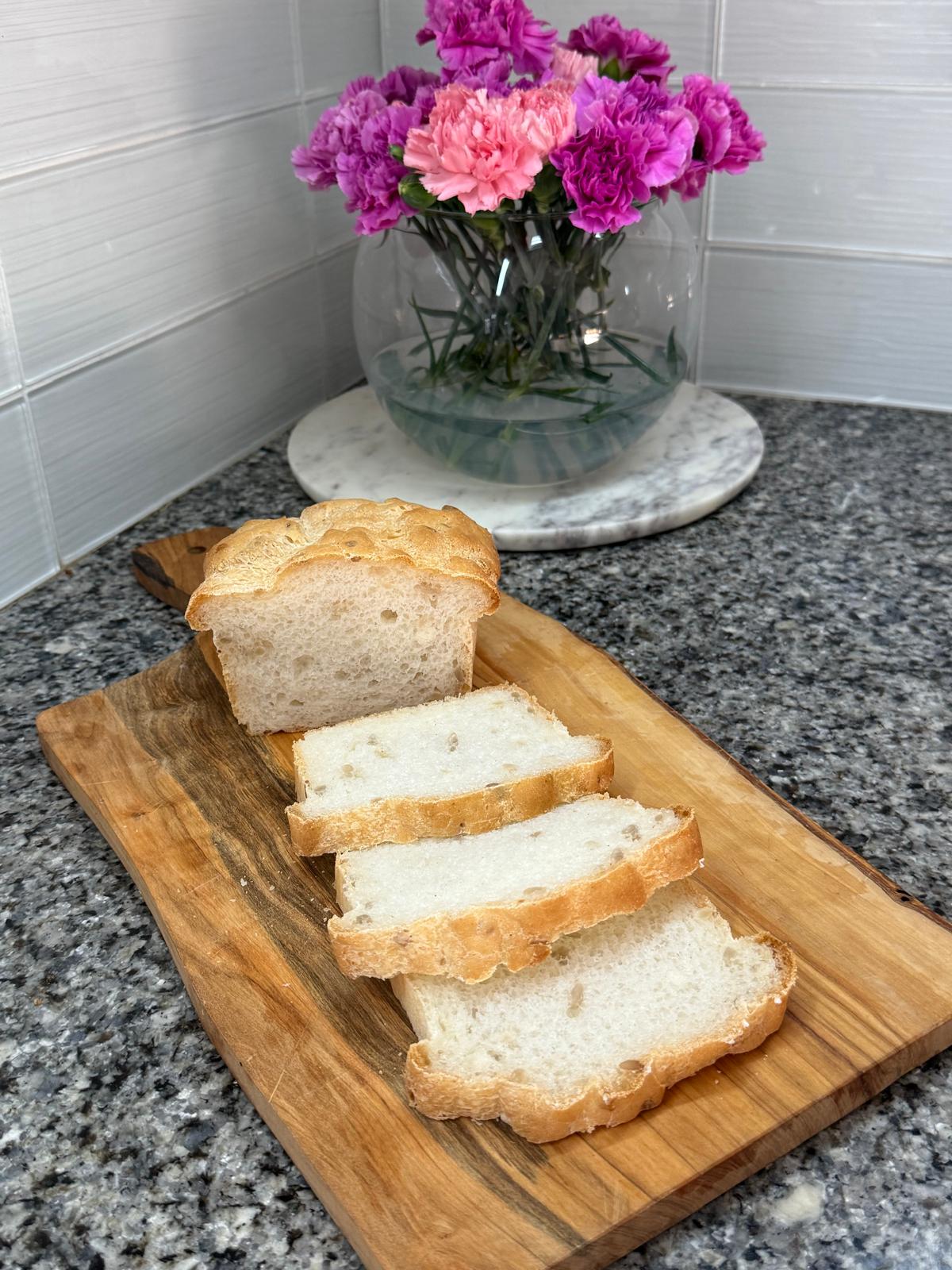 Sliced gluten-free seeded loaf on a board
