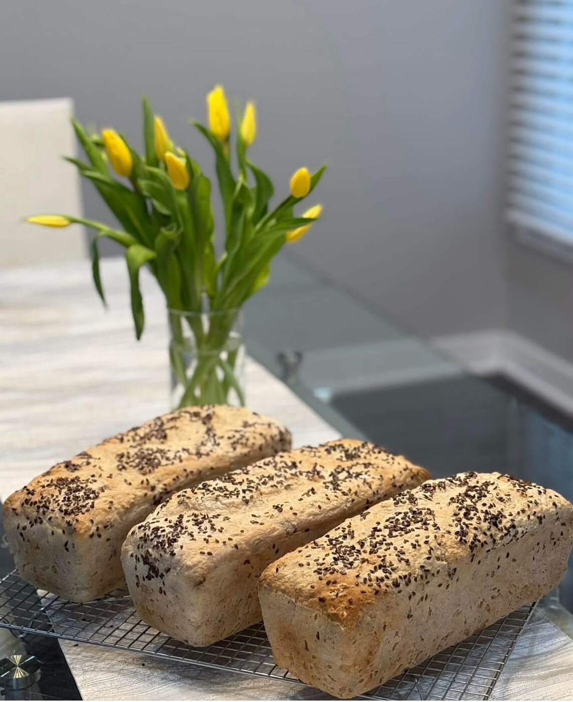 Fresh loaf with tulips on the counter