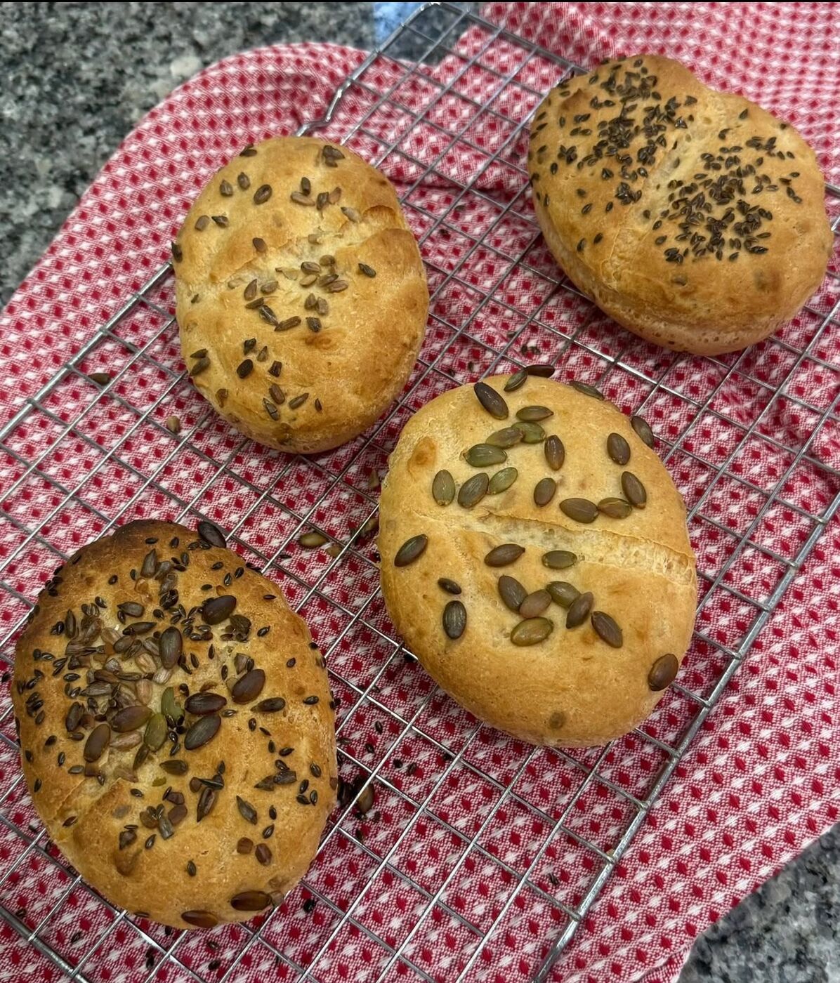 Seeded gluten-free rolls on a rack